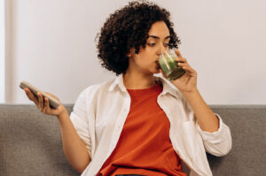 woman drinking calcium-rich green juice